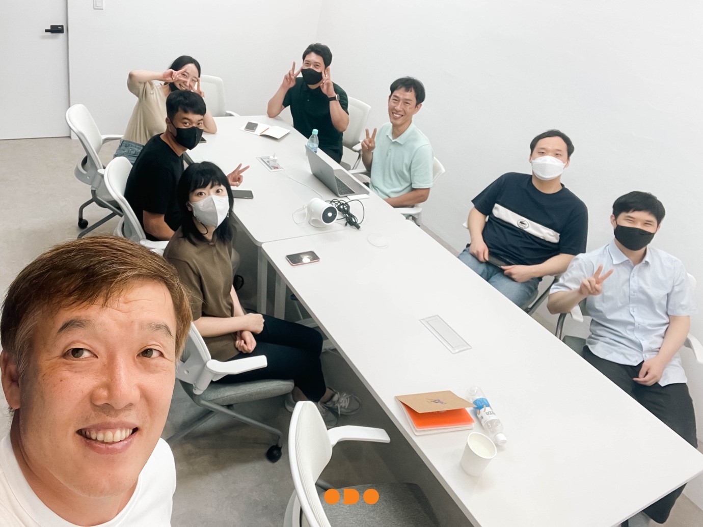 A group of people sitting around a table
Description automatically generated with medium confidence